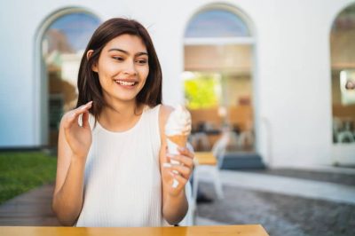 woman enjoying and eating an ice cream.