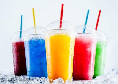 colorful frozen fruit slush drinks in plastic cups